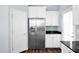 Bright kitchen featuring stainless steel appliances, white cabinets, and dark countertops for a modern look at 2534 N 73Rd Dr, Phoenix, AZ 85035