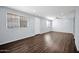 Bright living room with hardwood floors, neutral paint, a ceiling fan, and ample natural light at 2534 N 73Rd Dr, Phoenix, AZ 85035