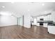 Spacious living room with hardwood floors connecting to the dining area and kitchen at 2534 N 73Rd Dr, Phoenix, AZ 85035