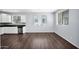 Open-concept living area and kitchen featuring stainless steel appliances, black countertops, and tile backsplash at 2534 N 73Rd Dr, Phoenix, AZ 85035