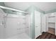 Clean, updated walk-in shower with bright walls, modern fixtures, and adjacent access to the closet at 2534 N 73Rd Dr, Phoenix, AZ 85035