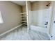 Bathroom featuring sleek, modern tub/shower, custom shelving and stylish marble tile flooring at 25745 W Peak View Rd, Wittmann, AZ 85361