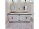 Modern bathroom features a dual sink vanity with gray counters, and a tiled shower at 25745 W Peak View Rd, Wittmann, AZ 85361
