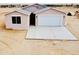 New home with a modern design, neutral colors, a two-car garage, and a concrete driveway at 25745 W Peak View Rd, Wittmann, AZ 85361