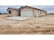 Home with attached two-car garage and desert landscaping at 25745 W Peak View Rd, Wittmann, AZ 85361