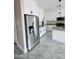 Modern kitchen showcasing white cabinetry, gray countertops, a kitchen island, and stainless steel appliances at 25745 W Peak View Rd, Wittmann, AZ 85361