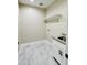 Well-lit laundry room with tiled floors, a utility sink, storage, and washer/dryer hookups at 25745 W Peak View Rd, Wittmann, AZ 85361