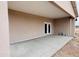 Covered outdoor patio with concrete flooring and access to the interior through double doors at 25745 W Peak View Rd, Wittmann, AZ 85361