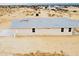 New single-story home with a light exterior, multiple windows, and a desert setting at 25745 W Peak View Rd, Wittmann, AZ 85361