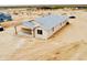 New single-story home with a light exterior, multiple windows, and a covered back patio at 25745 W Peak View Rd, Wittmann, AZ 85361