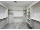 Spacious walk-in closet with custom shelving and rods for organization at 25745 W Peak View Rd, Wittmann, AZ 85361