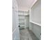 Bright walk-in closet with tiled floor, shelving, and hanging storage at 25745 W Peak View Rd, Wittmann, AZ 85361