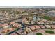 Panoramic aerial view captures a suburban community featuring tree-lined streets, ponds and mountain views at 2722 N 155Th Dr, Goodyear, AZ 85395