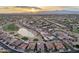 Breathtaking sunset aerial view overlooking a vibrant community with a scenic lake and golf course at 2722 N 155Th Dr, Goodyear, AZ 85395