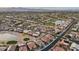 Panoramic aerial view of a golf course community with serene lakes and meticulously maintained homes at 2722 N 155Th Dr, Goodyear, AZ 85395