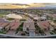 Aerial perspective of a lovely home in a golf course community with a beautiful sunset backdrop at 2722 N 155Th Dr, Goodyear, AZ 85395