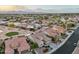 Expansive aerial view of a desert community showcasing lush landscaping and stunning mountain views at 2722 N 155Th Dr, Goodyear, AZ 85395