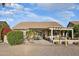 Backyard patio area with dining set, seating and mature landscaping at 2722 N 155Th Dr, Goodyear, AZ 85395