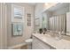 Bright bathroom features a granite vanity, framed mirror, and a shower tub at 2722 N 155Th Dr, Goodyear, AZ 85395