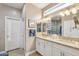 Bathroom with double sink vanity, framed mirrors, and walk-in shower with bright natural light at 2722 N 155Th Dr, Goodyear, AZ 85395