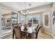 Bright dining area featuring a stylish chandelier, sleek modern windows, and a sliding glass door to the outdoor living space at 2722 N 155Th Dr, Goodyear, AZ 85395