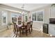 Sunlit dining room with a wooden table, upholstered chairs, and beautiful views through shuttered windows at 2722 N 155Th Dr, Goodyear, AZ 85395