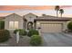 Charming single-story home featuring a well-manicured lawn, desert landscaping, and a neutral-colored exterior at 2722 N 155Th Dr, Goodyear, AZ 85395