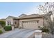 Front exterior view of a home with a two-car garage, desert landscaping, and a tile roof at 2722 N 155Th Dr, Goodyear, AZ 85395