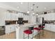Modern eat-in kitchen with stainless steel appliances, stylish lighting, and a breakfast bar with comfortable seating at 2722 N 155Th Dr, Goodyear, AZ 85395