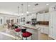 Bright kitchen features granite counters, stainless appliances, white cabinetry, and breakfast bar seating at 2722 N 155Th Dr, Goodyear, AZ 85395