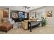Beautiful living room with a cozy seating area, modern entertainment center, and large windows overlooking the golf course at 2722 N 155Th Dr, Goodyear, AZ 85395