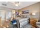Spacious main bedroom features hardwood floors, a ceiling fan, and an ensuite bathroom at 2722 N 155Th Dr, Goodyear, AZ 85395