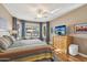 Well-lit main bedroom features hardwood floors, window seating, and a ceiling fan at 2722 N 155Th Dr, Goodyear, AZ 85395