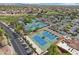 Aerial view of well-maintained tennis courts with lush landscaping and ample parking at 2722 N 155Th Dr, Goodyear, AZ 85395
