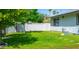Lush green backyard with a white block fence for privacy and a view of the home at 313 E Westchester Dr, Tempe, AZ 85283