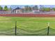 Exterior shot of a baseball field with batting cage and covered bleachers at 313 E Westchester Dr, Tempe, AZ 85283