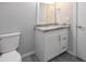 Bathroom features a white vanity with granite counters, a white framed mirror, and wood-look tile flooring at 313 E Westchester Dr, Tempe, AZ 85283
