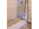 This bathroom features a shower with stone pebble floor and tile surround at 313 E Westchester Dr, Tempe, AZ 85283