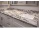 This bathroom features a double sink vanity with white cabinets and granite countertops at 313 E Westchester Dr, Tempe, AZ 85283