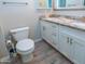 This bathroom features a toilet, wood-look tile floor and double sink vanity at 313 E Westchester Dr, Tempe, AZ 85283