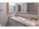 Bathroom with double sink vanity, granite countertop, and framed mirrors at 313 E Westchester Dr, Tempe, AZ 85283