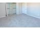 Bright bedroom features neutral walls, carpet, and a closet with shelving for optimal storage at 313 E Westchester Dr, Tempe, AZ 85283
