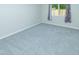 Bright bedroom featuring white walls, grey carpet, white trim and large window at 313 E Westchester Dr, Tempe, AZ 85283