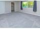 Neutral bedroom featuring grey carpeting, closet, and view to exterior at 313 E Westchester Dr, Tempe, AZ 85283