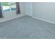 This bedroom features neutral carpet, white trim and a window for natural light at 313 E Westchester Dr, Tempe, AZ 85283