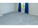 Bright bedroom featuring white walls, grey carpet, white trim and double door closet at 313 E Westchester Dr, Tempe, AZ 85283