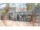 Baseball dugout view with fencing and industrial style building in the background at 313 E Westchester Dr, Tempe, AZ 85283