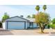 Charming single-story home with desert landscaping, a two-car garage, and mature palm trees at 313 E Westchester Dr, Tempe, AZ 85283