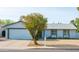 Inviting single-story home featuring a spacious front yard with mature trees and a two-car garage at 313 E Westchester Dr, Tempe, AZ 85283