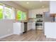 Bright kitchen features white cabinets, stainless steel appliances, stone countertops, and window view at 313 E Westchester Dr, Tempe, AZ 85283